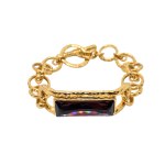 Gold-plated bracelet with a striking burgundy Swarovski crystal