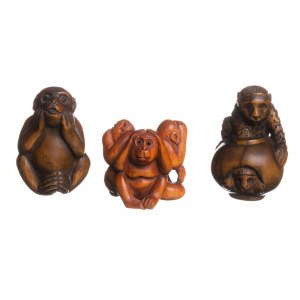 Three wooden netsuke figurines depicting monkeys