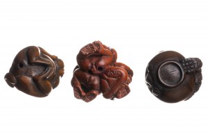 Three wooden netsuke figurines depicting monkeys