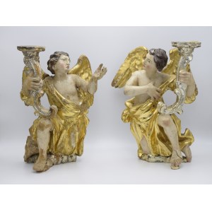 A pair of angels holding candlesticks