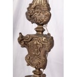 Altar candlestick late 18th early 19th century 100 x 32 cm in silver metal sheet. Embossed and engraved parts. Triangular shape with three zoomorphic support feet State of preservation: fair, broken and restored parts., Altar candlestick late 18th early 1