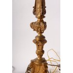 Lot of two electrified brass candlesticks first half of the 20th century 42 x 10 cm triangular in shape, Baroque style, raised parts with rocaille decoration State of preservation: very good, Lot of two electrified brass candlesticks first half of the 20t