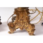 Lot of two electrified brass candlesticks first half of the 20th century 42 x 10 cm triangular in shape, Baroque style, raised parts with rocaille decoration State of preservation: very good, Lot of two electrified brass candlesticks first half of the 20t
