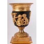 Pair of potiches second half of the 19th century 41 x 17 x 13 cm plinth base in yellow Siena marble with four quadrangular gilded bronze feet. Chalice stand in gilded bronze with a band of cupids along the body on a black background. State of preservation