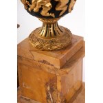 Pair of potiches second half of the 19th century 41 x 17 x 13 cm plinth base in yellow Siena marble with four quadrangular gilded bronze feet. Chalice stand in gilded bronze with a band of cupids along the body on a black background. State of preservation