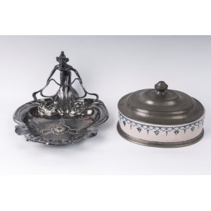 Lot of two pewter pocket empties France, first half of the 20th century 17 x 27 x 23.5cm; 14 x 21 x 17.5 cm one with an open triangular shape with a lady holding a stylised leaf, the other with an oval-shaped box with a pewter base and lid and a ceramic b
