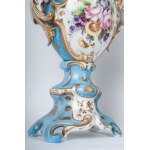 Pair of polychrome porcelain potiches France, second half of the 19th century 35 x 15 cm Baroque style with baluster body and flared shell-shaped foot and bud-shaped upper rim. Floral decoration within reserve on a white background with pure gold finishes