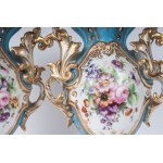 Pair of polychrome porcelain potiches France, second half of the 19th century 35 x 15 cm Baroque style with baluster body and flared shell-shaped foot and bud-shaped upper rim. Floral decoration within reserve on a white background with pure gold finishes
