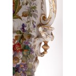 Porcelain vase first quarter of the 20th century 64 x 20 x 19 cm with a baluster tapered downwards with a disc-shaped support foot, rounded shoulder, long neck with a slightly everted rim. Handle grips. Floral decoration on a white background with musical