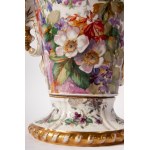 Porcelain vase first quarter of the 20th century 64 x 20 x 19 cm with a baluster tapered downwards with a disc-shaped support foot, rounded shoulder, long neck with a slightly everted rim. Handle grips. Floral decoration on a white background with musical