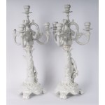 Pair of four-light candelabra 50 x 16 cm in Baroque style porcelain in white monochrome with base and rocailles accompanied by male and female characters with satyr and putto. Ginori manufacture, first half of the 20th century State of conservation: missi