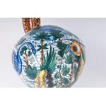 &quot;Drink if you can&quot; first quarter of the 20th century 22 x 29 x 11 cm in polychrome ceramic with peacock, leaf and shrub decoration. Globular shape tapered towards the bottom with disc foot, comma-shaped spout and spiral handle. Signed on the bas