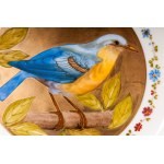 Lot of six knife plates diameter 24.6 x 2.6 cm in polychrome porcelain with a golden brim and blue trim. Wide white-bottomed hollow with a reproduction of a bird within a golden reserve. Ring-shaped back on a lowered background with a blue manufacturing s