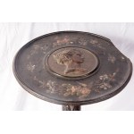 Gueridon 19th century 80 x 45 cm made of ebonized wood with a circular support surface with a female profile in relief in the centre, a caryatid stem and a three-legged support. State of conservation: missing and broken parts, Gueridon 19th century 80 x 4