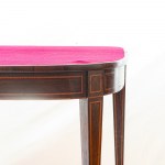 Mahogany book-style table late 19th early 20th century closed 76 x 92 x 42 cm; open 74 x 92 x 89 cm rectangular in shape with rounded corners, with four tapered truncated conical legs tapering towards the bottom. Red cloth top, rectangular decorative elem