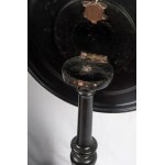 Pair of sailing gueridons early 20th century 72 x 46 cm round top with effigy of male and female warriors, spindle-shaped shaft with central ring tapered towards the bottom, ending with three comma-shaped support feet. In black monochrome, the surfaces of