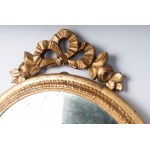 round wall mirror 20th century diameter 47 cm; with top 53 cm in gilded wood carved with palmette motifs along the upper edge and a bow-shaped top with flowers. State of preservation: good with wear to the gilding as per use over time, round wall mirror 2