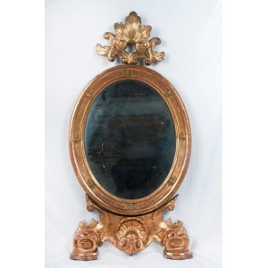 Oval shaped mirror in gilded and carved wood 19th century 114 x 56 x 9 cm with leaf-shaped top and legs with shell and scrolls. Angel heads decorate the frill of the mirror. State of conservation: some missing gilding., Oval shaped mirror in gilded and ca