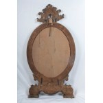 Oval shaped mirror in gilded and carved wood 19th century 114 x 56 x 9 cm with leaf-shaped top and legs with shell and scrolls. Angel heads decorate the frill of the mirror. State of conservation: some missing gilding., Oval shaped mirror in gilded and ca