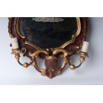 Lot of two wall sconces with mirror first half of the 20th century of baroque shapes: one with a rectangular profile in silvered wood with two lights with a cymatium, sides and base with racemes and floral motifs 75 x 60 cm; the other with a mixtilinear p