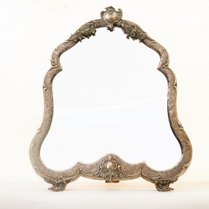 Free-standing mirror 1894 60 x 47 x 3 cm in 800/1000 silver and wood, with a curved line and two comma-shaped feet. Engraved parts, and in floral relief, coat of arms at the apex. Hallmark and signature at the base. Condition: good., Free-standing mirror 