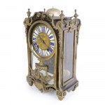 Table clock 18th century 35 x 22 x 12 cm with circular dial in gilded bronze and engraved with floral reliefs, with Roman numerals in blue on white enamel and Arabic numerals on the outer edge, it has two holes for winding and striking. Movement with wire