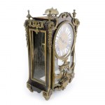 Table clock 18th century 35 x 22 x 12 cm with circular dial in gilded bronze and engraved with floral reliefs, with Roman numerals in blue on white enamel and Arabic numerals on the outer edge, it has two holes for winding and striking. Movement with wire