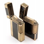 ST. DUPONT -Lot of two lighters- Bodies laminated in gold co...