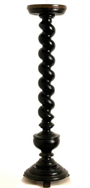 Ebonized wood twist column resting on round base raised on three feet