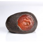 A Roman carnelian intaglio set in a silver ring. Three pigs.