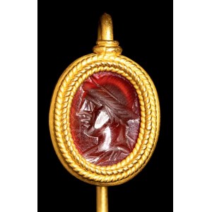A Roman carnelian intaglio set in a gold stick pin. Apollo.