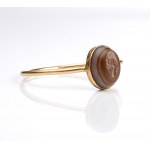 A small Roman agate intaglio set in a later gold ring. Fortuna-Tyche.