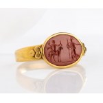 A Roman gold ring set with a red jasper intaglio. Hermes and Athena.