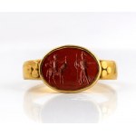 A Roman gold ring set with a red jasper intaglio. Hermes and Athena.