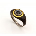 A Roman nicolo intaglio set in a iron and gold ring (restored with silver). Gorgona head.