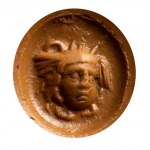 A Roman nicolo intaglio set in a iron and gold ring (restored with silver). Gorgona head.