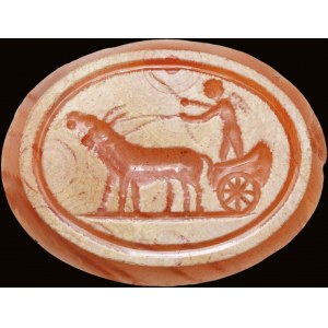 A partially burnt agate intaglio. Erote on a chariot drawn by two goats.