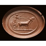 A partially burnt agate intaglio. Erote on a chariot drawn by two goats.