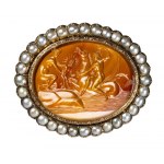 A fine Neoclassical carnelian intaglio set in a gold chiseled brooch with pearls. Mythological scene.