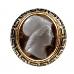 A Neoclassical agate cameo set in a gold and black enamel ring.