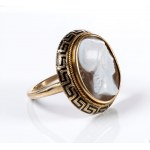 A Neoclassical agate cameo set in a gold and black enamel ring.