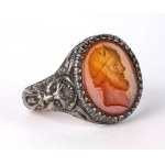 A postclassical carnelian intaglio set in a later silver ring. Male head.