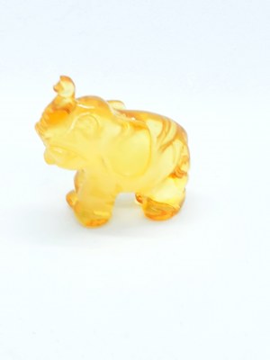 Hand-carved translucent elephant figurine made of natural Baltic amber