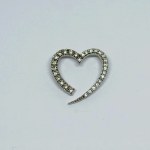 Silver pendant in the form of a heart with white zircons