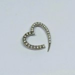 Silver pendant in the form of a heart with white zircons