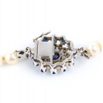Pearl necklace and gold brooch with diamonds and sapphires