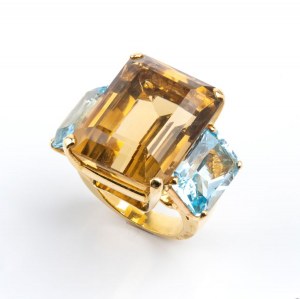 Gold band ring set with smoky quartz flanked by two blue topazes