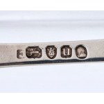 A goup of four silver spoons and a pair of scissors