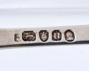A goup of four silver spoons and a pair of scissors