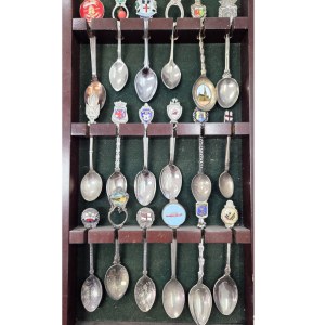 Set of collectible spoons in a wooden display case